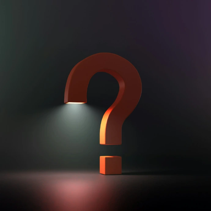 A large orange question mark illuminated by a bright light from below